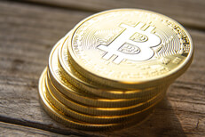 View of leaning stack of bitcoins View from top of leaning stack of bitcoins on wood plank background