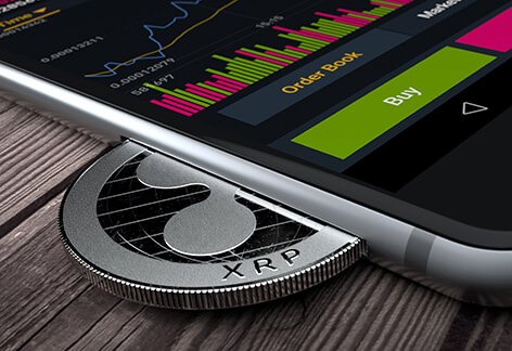 iPhone with Ripple coin in slot iPhone with Ripple XRP coin inserted into slot concept for mobile XRP apps, profits, or trades