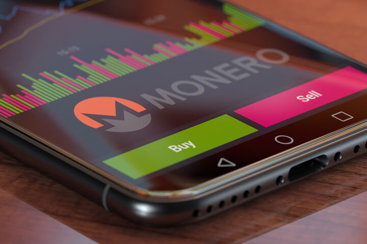 Monero exchange app on iPhone X screen showing Monero logo, trading volume, and option to buy or sell cryptocurrency
