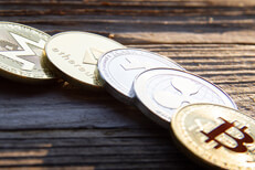 Row of crypto coins in morning light Row of cryptocurrency coins in morning light with hard shadows