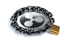 Ripple XRP coin locked with chain Ripple XRP coin wrapped in heavy chain and locked with brass padlock