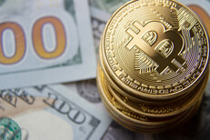 Top view stack of bitcoins Top view of a stack of bitcoins on 100 dollar bills