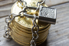 Stack of Bitcoins secure on wood Stack of Bitcoins locked with padlock and chains on weathered wood background