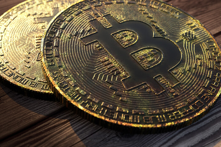 Two Bitcoins with tarnish, corrosion, and patina on wood background