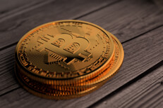 Three Bitcoins on weathered wood Stack of three Bitcoins resting on weathered wood planks
