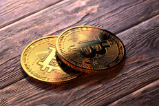 Two Bitcoins on wood floor Two Bitcoins on stained wood floor reflecting window light