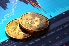 Bitcoins on laptop screen showing price decline Two Bitcoins on laptop screen showing BTC price area chart with sharp decline and recovery