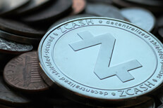 Zcash coin on assorted currency close Zcash cryptocurrency coin on pile of assorted tarnished U.S. currency coins close up