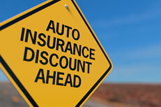 Yellow road sign reading Auto Insurance Discount Ahead