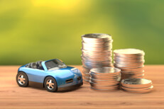 Blue toy convertible next to stacks of coins