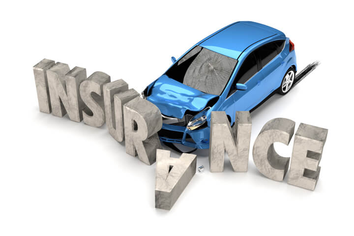 Auto insurance concept photo of blue car crashed into large stone insurance letters