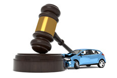 Car crashing into gavel Car crashed into gavel liability insurance concept image