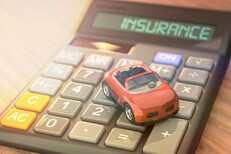 Insurance calculator with toy car and flare effect Insurance calculator with small red toy car and light flare effect