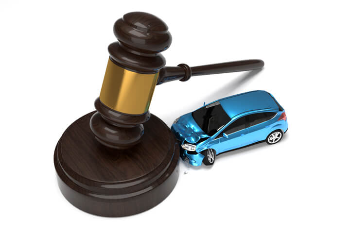 Blue car crashed into base of gavel isolated on white liability insurance concept image