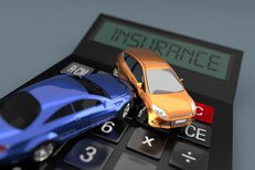Toy cars on insurance calculator Two car accident on insurance calculator on blue/grey background
