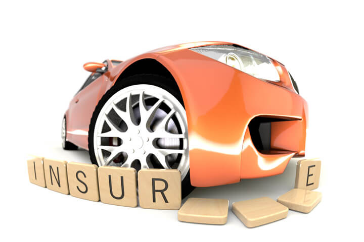 Orange car sliding through wooden insurance letters fish eye viewpoint