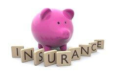 Piggy bank with insurance wood letters Pink piggy bank with wood insurance letters isolated on white background