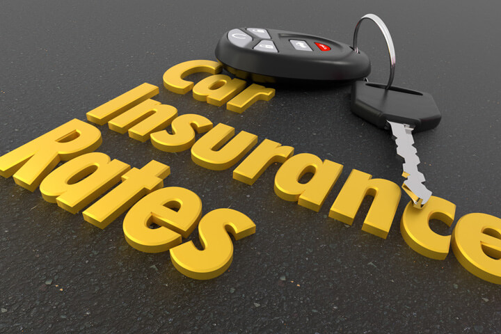 Car keys and key fob on blacktop with text car insurance rates in foreground