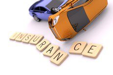 Two car rollover accident on white background with displaced wooden insurance letters