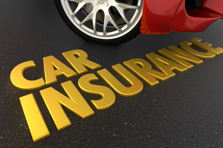 Shiny gold car insurance text on blacktop under sports car bumper