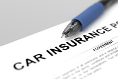 Car insurance policy with pen Close up of car insurance policy with blue ink pen