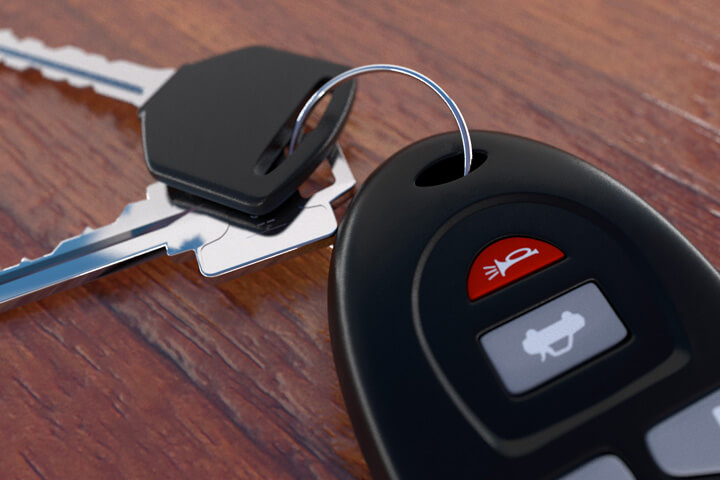 Close up image of car keys on wood desk