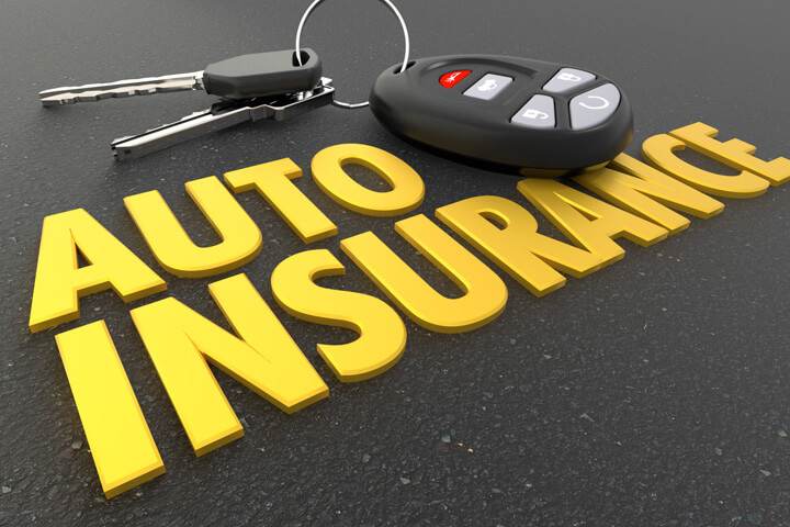 Car keys on ground with shiny gold auto insurance words