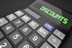 Car insurance discounts calculator Calculator showing LCD word Discounts on dark background