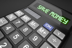 Save money calculator Calculator on dark background with LCD text reading Save Money