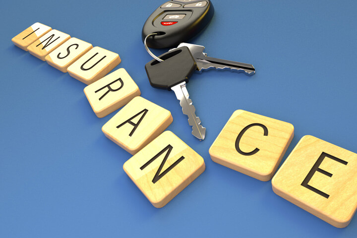 Insurance letters on blue background with car keys