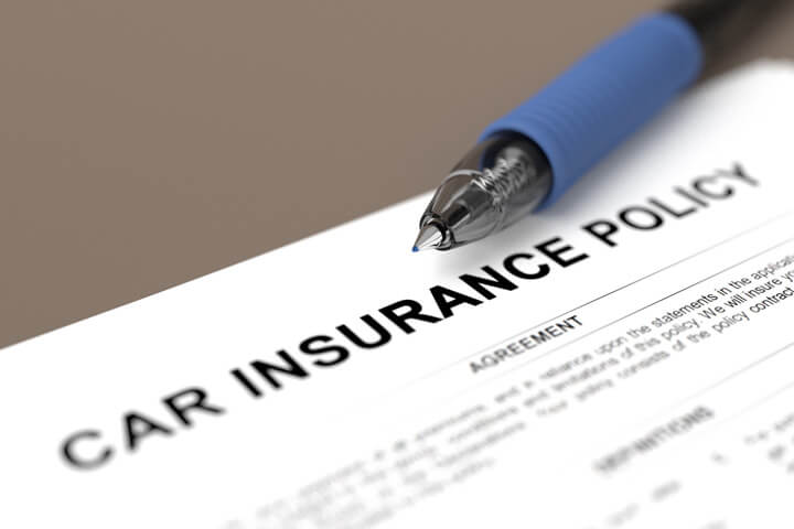 Close up of car insurance policy with blue ball point pen