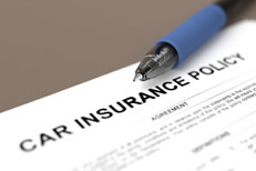 Car insurance policy with pen Close up of car insurance policy with blue ball point pen