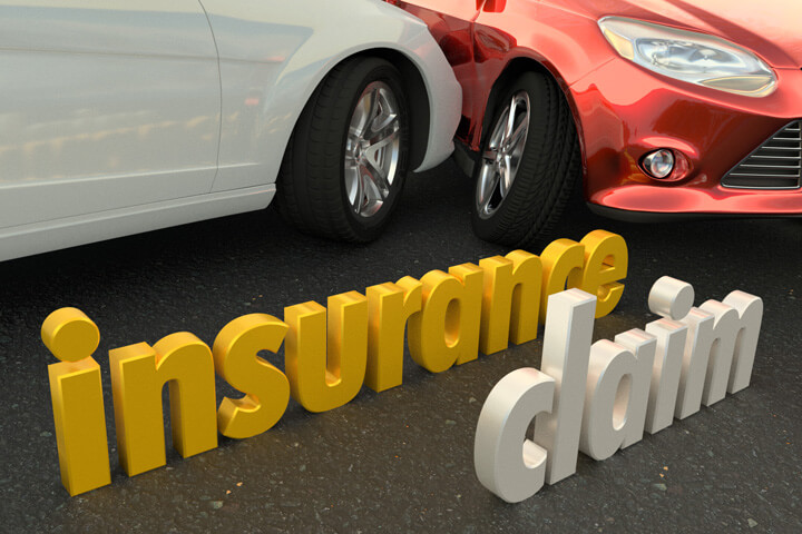 Two car accident in background with words insurance claim in foreground