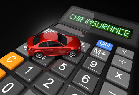 Toy car on car insurance calculator Small red toy car on car insurance calculator on dark background