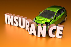 Car crashed into insurance letters Small green compact car crashed into insurance word on orange background