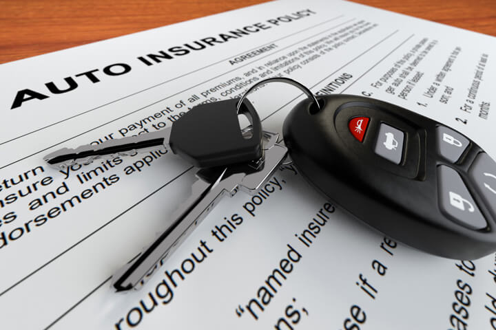 Close up of auto insurance policy and car keys