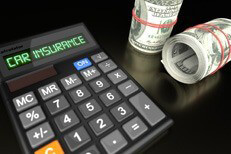 Car insurance calculator with money rolls Calculator with LCD reading Car Insurance with two rolls of one hundred dollar bills