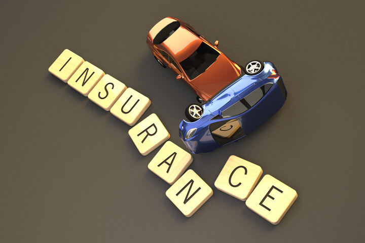 Two vehicle rollover accident on darker background displacing wood insurance letters