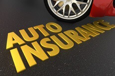 Gold auto insurance text on road in front of red sports car