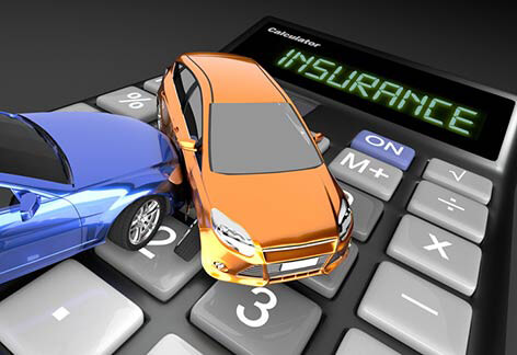 Toy car accident on calculator Two car accident on calculator reading Insurance close perspective