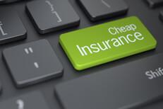 Cheap insurance keyboard key Laptop keyboard with green cheap insurance key concept for buying affordable insurance