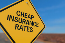 Cheaper insurance rates road sign Yellow road sign reading Cheaper Insurance Rates