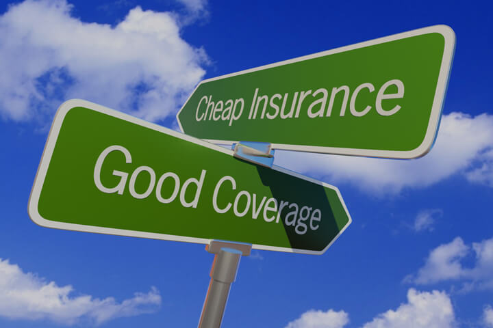 Street sign with arrows reading Cheap Insurance and Good Coverage pointing in opposite directions
