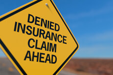Road sign for denied insurance claim Yellow road sign reading Denied Insurance Claim Ahead
