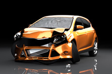 Orange compact car with accident collision damage on dark background