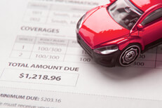 Auto insurance billing notice Auto insurance bill showing total amount due with small red toy car