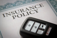 Photo of a vehicle keyless entry remote on an insurance policy certificate