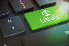 Keyboard with Liability key lens flare Dark laptop keyboard with green Liability key and corner lens flare