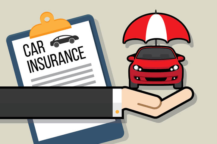 Hand holding small car with insurance protection umbrella and car insurance policy in background