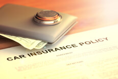 Wallet on policy with flare Wallet with coins and cash on car insurance policy with light flare and overlay effect